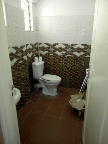 a bathroom with a toilet and a sink at Kenya Inn in Nairobi