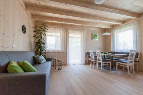 a living room with a couch and a table and chairs at Winklerhof Apartments in Brunico