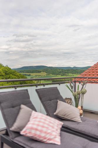 a balcony with two pillows and a view at Romantik Hotel Ahrenberg in Bad Sooden-Allendorf