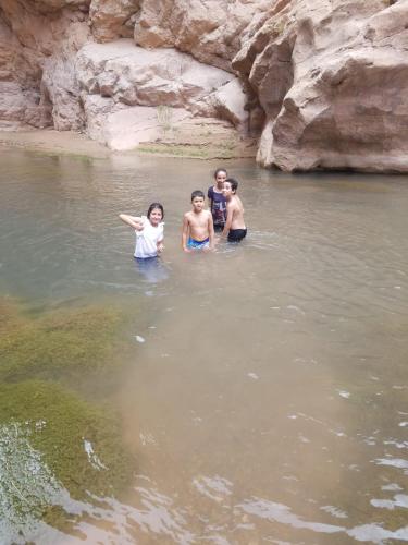 a group of people standing in the water at Auberge oued dades in Boumalne