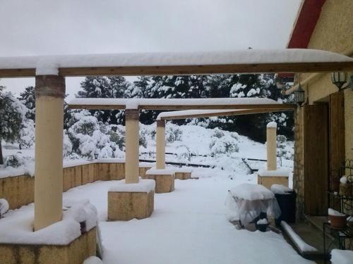 a gazebo covered in snow in a yard at Mas Arboretum in La Pobla de Cérvoles