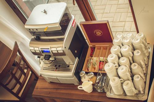 a large espresso machine sitting on a table with cups at Rodinné Vinařství Skoupil in Velké Bílovice