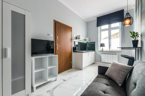 a living room with a couch and a kitchen at Panorama Przemyśl in Przemyśl