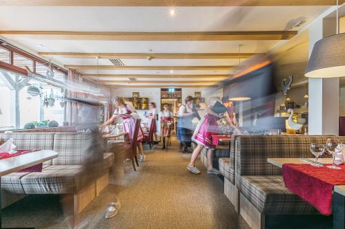 a group of people sitting at a restaurant at Romantik Hotel Ahrenberg in Bad Sooden-Allendorf