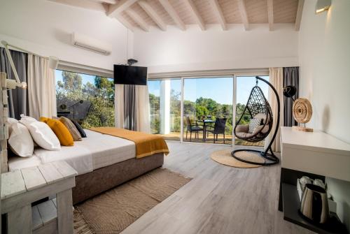 a bedroom with a bed and a large window at Monte Das Alpenduradas in Zambujeira do Mar