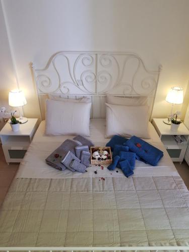 a bedroom with a white bed with two night stands at 'Seaside Paradise' Elegant Apartment in Nea Makri in Nea Makri