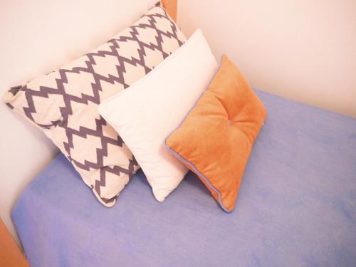 two pillows sitting on top of a bed at Cangosta House in Fão