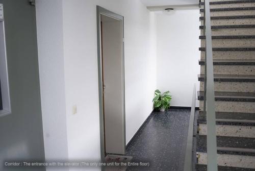 a hallway with a door and stairs in a building at 71 square meters Condo in Schwarzwald with beautiful mountain view, free wifi in Schonwald im Schwarzwald