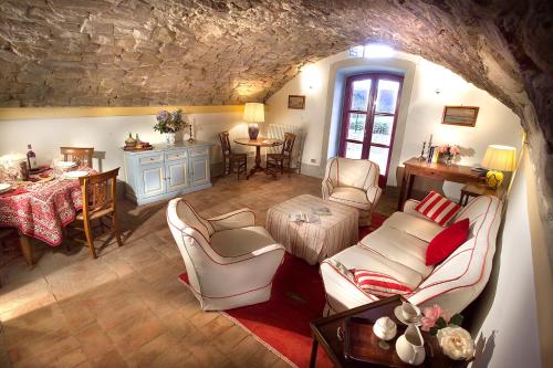 a living room with couches and a table and chairs at Romantic House in Greve in Chianti