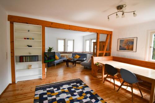 a living room with a table and chairs at Villa Sophie in Bad Herrenalb