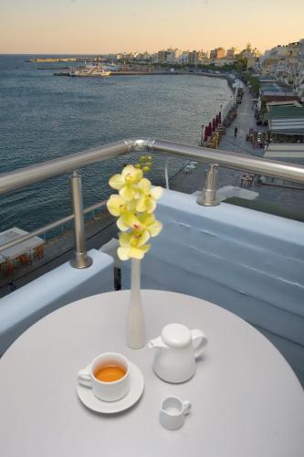 a vase of flowers on a table on a cruise ship at Astron Hotel in Ierápetra