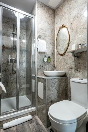 a bathroom with a shower and a toilet and a sink at Cappadocia Guest House in Brighton & Hove