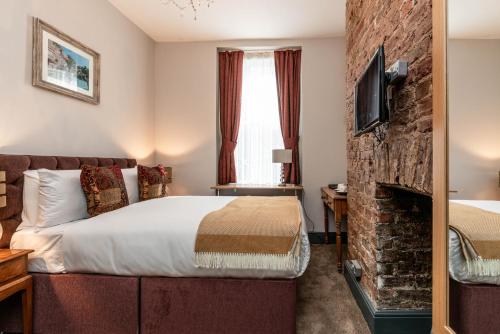 a hotel room with a bed and a fireplace at Cappadocia Guest House in Brighton & Hove