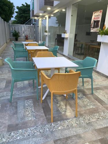 a row of tables and chairs on a patio at Hotel Metropolitano Plaza in Valledupar