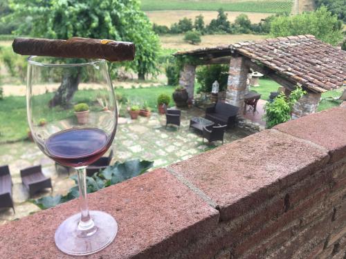 a glass of wine sitting on a brick wall at Podere Terreno alla via della volpaia in Radda in Chianti