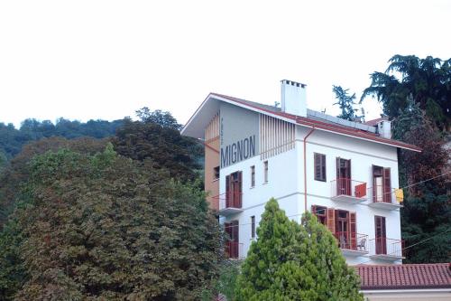 a white building with a sign on top of it at Hotel Mignon in Trieste