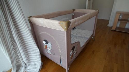 a baby crib with a bed in a room at PENTHOUSE STOLIV Villa located 5 meters from the sea SPA-Pool Exclusive Terrace,Private Jetty Sunbeds, Pebble Beach, Secluded location Total area 375m2 at your disposal in Kotor