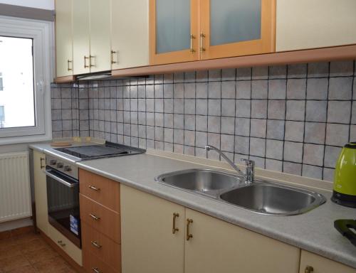 a kitchen with a sink and a stove at White Tower Apartment in Thessaloniki