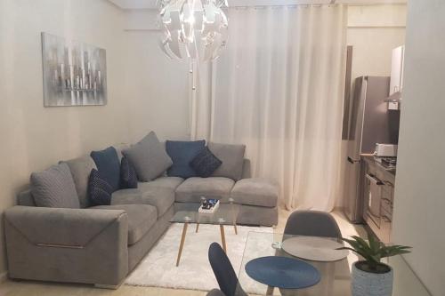 a living room with a couch and a table at A 200m de la Plage, du Haut Standing au coeur du Parc in Mohammedia