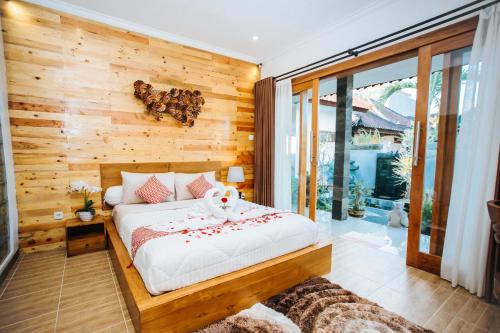 a bedroom with a bed with a stuffed animal on it at Dong Jegeg Canggu in Canggu