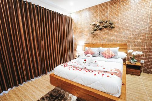 a bedroom with a bed and a brick wall at Dong Jegeg Canggu in Canggu