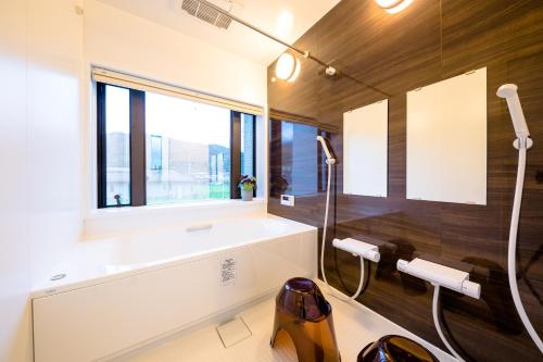 a bathroom with a shower and a sink and a window at Erable Mt.Fuji "Zen" in Fujikawaguchiko