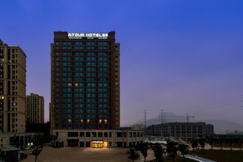 a tall building with a sign on top of it at Atour Hotel (Wenzhou International Airport Olympic Sports Center) in Wenzhou