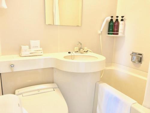 a white bathroom with a sink and a toilet at Ai Hotel Ageo in Ageo