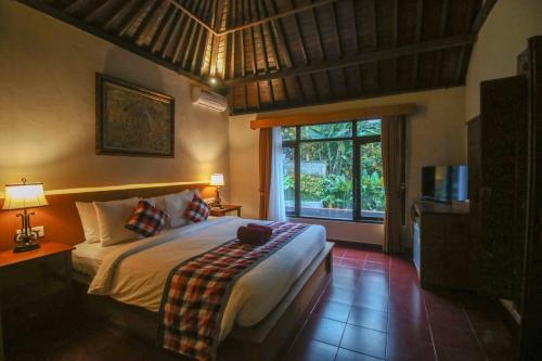 Ένα ή περισσότερα κρεβάτια σε δωμάτιο στο Aji Lodge Bungalow