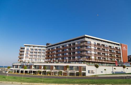 a large hotel building with a street in front of it at PARADISO 308-309 Private Studios Nessebar in Nesebar