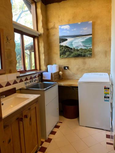 a kitchen with a sink and a refrigerator at Denmark Forest Retreat in Denmark
