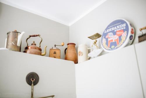 a shelf with bottles and utensils in a kitchen at Villa Marienholm in Haapsalu