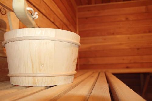a bucket sitting on top of a wooden table at Pensiunea Mușatinii in Putna