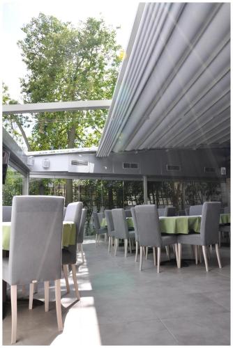 a row of chairs and tables on a patio at Astron Hotel in Ierápetra