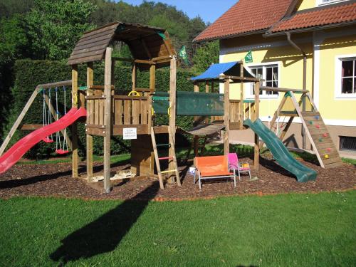 a playground with a slide and a swing set at Gasthof Gnasmüller in Totzenbach