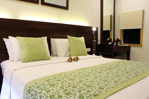 a large bed with two teddy bears sitting on it at Bali Agung Village - CHSE Certified in Seminyak