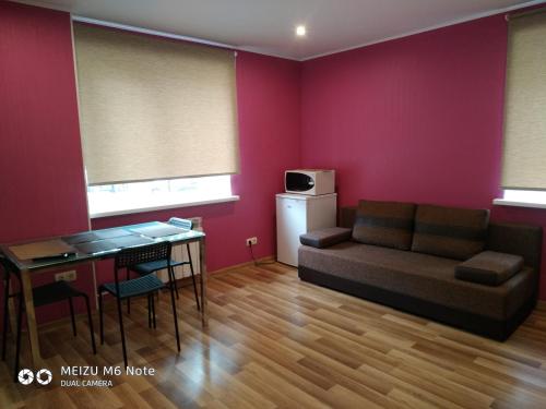a living room with a couch and a table at Sparta Apartments Bastrakovi in Narva