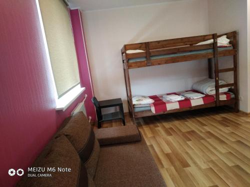 a room with two bunk beds and a window at Sparta Apartments Bastrakovi in Narva