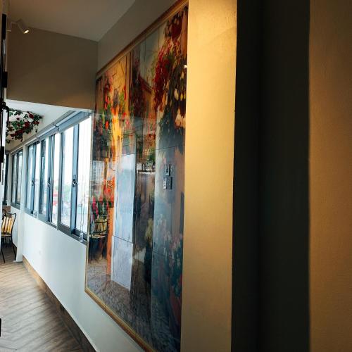 a large painting hanging on a wall in a hallway at Hanoi La Cascada House & Travel in Hanoi