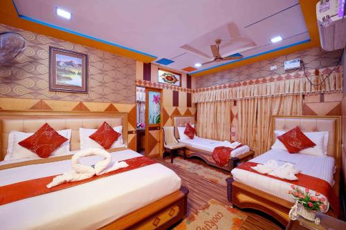 a bedroom with two beds with towels on them at Hotel Shri Swarna's Palace - A Business Class Hotel in Tiruchchirāppalli