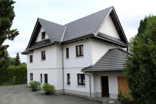 a white house with a black roof at Ferienhaus Kaiserhof in Markkleeberg
