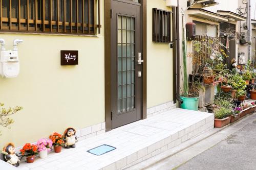 a front door of a house with potted plants at HAKU Wamikyo in Kyoto
