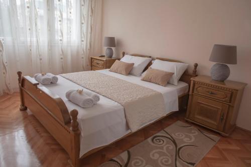 a bedroom with a large bed with two towels on it at Apartman Preko Morace 2018 in Podgorica