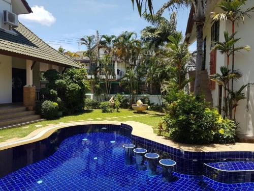 a pool in the backyard of a house at Private Pattaya Resort in Nong Prue
