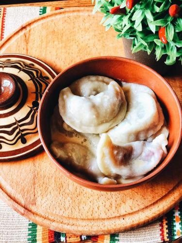 two donuts in a bowl on a wooden plate at Dachna Sadyba PB in Migovo