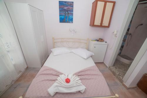 a bedroom with a bed with a towel on it at Amorgaia 2 in Katapola