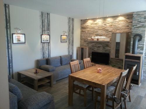 a living room with a table and a couch at Ferienhaus Michelson in Ostseebad Karlshagen