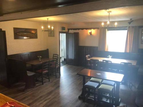 a restaurant with tables and chairs and a dining room at The Griffin Llyswen in Brecon