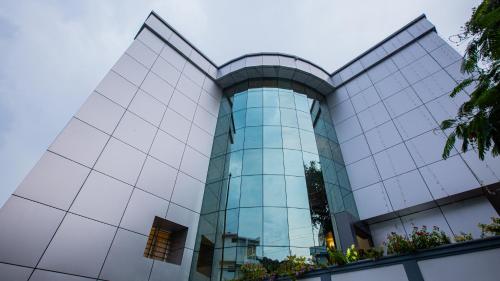 an office building with a glass facade at Woodside residency in Thekkady