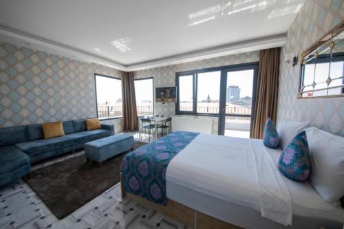 a hotel room with a large bed and a couch at ROYAL TAKSIM SUITES in Istanbul